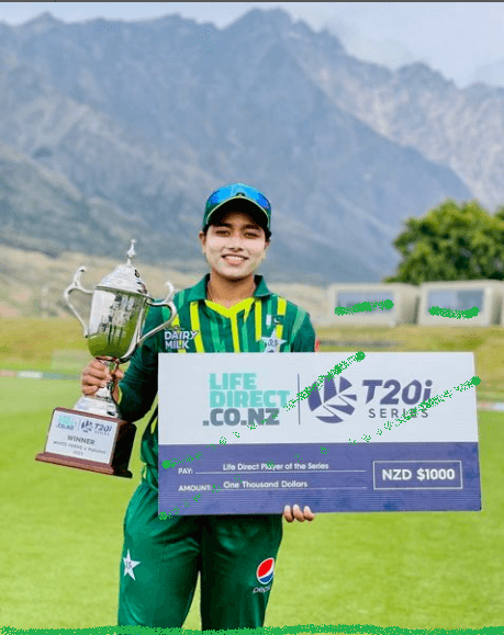 a woman holding a trophy and a sign Fatima Sana khan